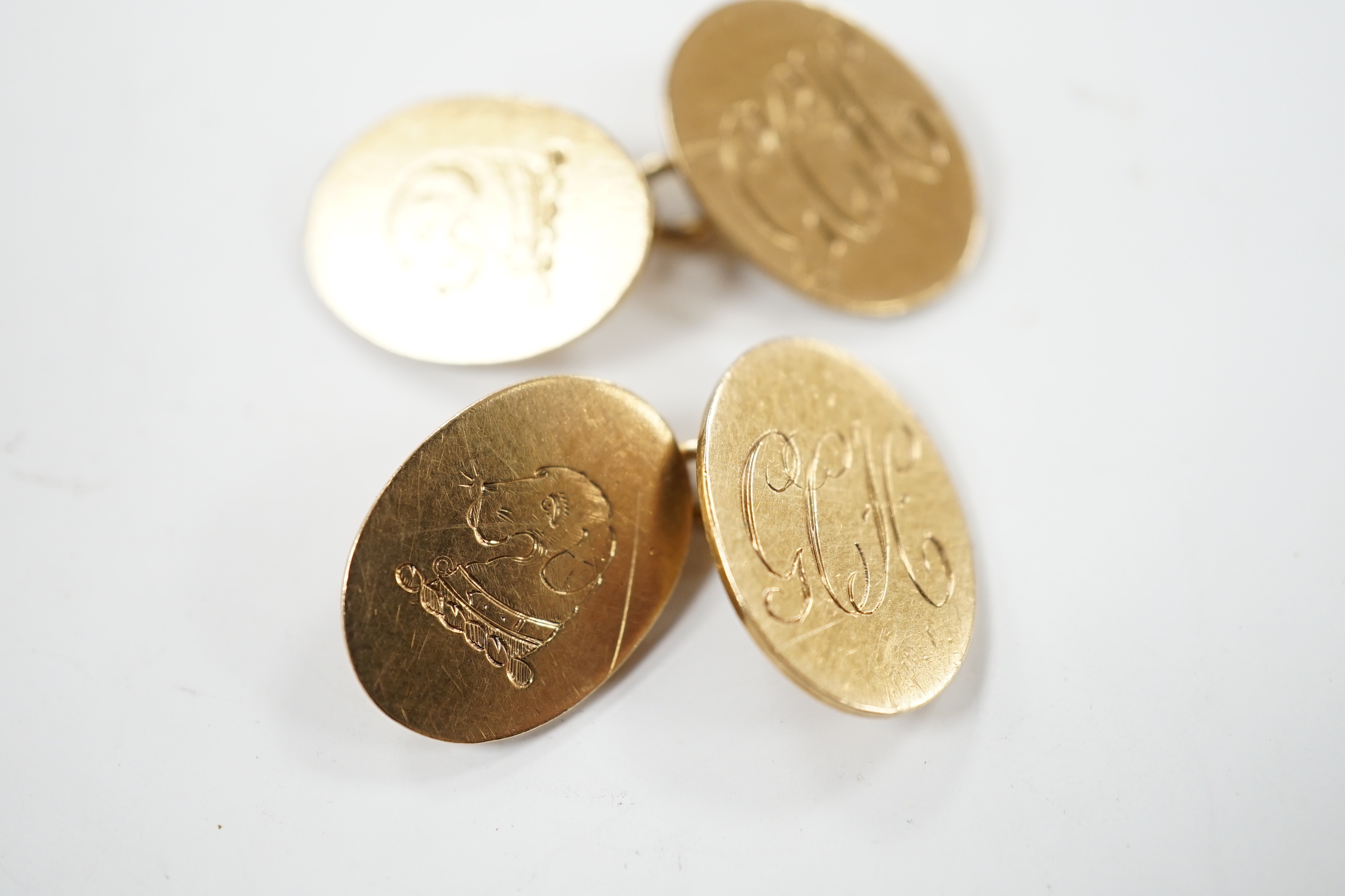 A pair of early 1960's 9ct gold oval cufflinks, with engraved crest and monogram, 10.3 grams.